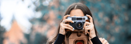 woman hand vintage camera in the parkの写真素材