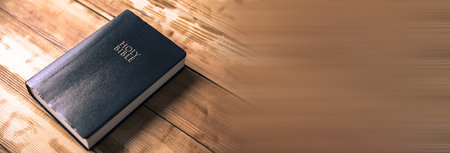 Holy Bibleon the wooden table backgroundの写真素材