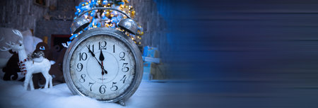 Christmas background. Alarm clock and christmas lights