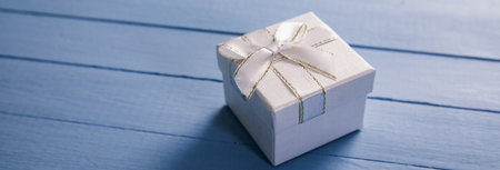 Gift box with ribbon on blue backgroundの写真素材