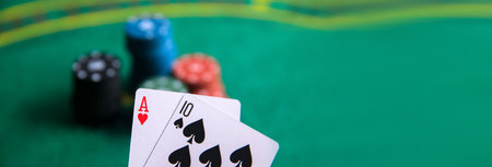 Pair of aces with poker chips on the poker table