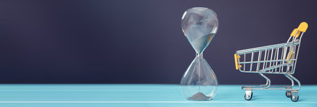 hourglass and shopping cart on the table