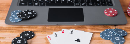 poker aces and chips on the computer laptop