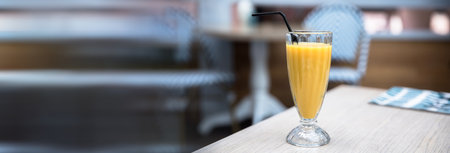 yellow juice on the table in cafeの写真素材