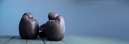 gloves for boxing on the wooden tableの写真素材