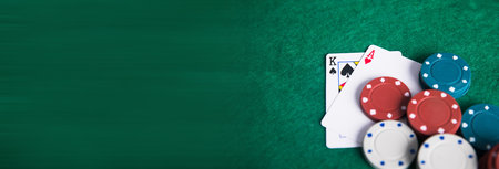 poker chips on cards on green background