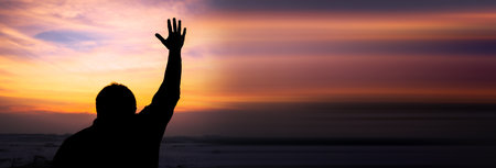 Human hands open palm up worship at the sunsetの写真素材