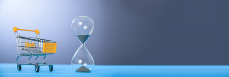 Shopping cart and hourglass on the blue background