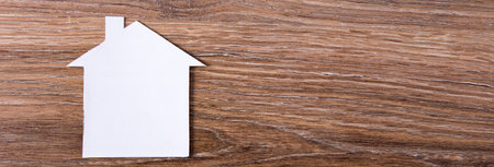 paper house model on wooden backgroundの写真素材