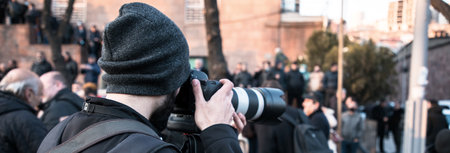 man photographer hand camera in the demonstrationの写真素材