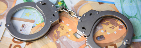 the handcuffs on the money backgroundの写真素材