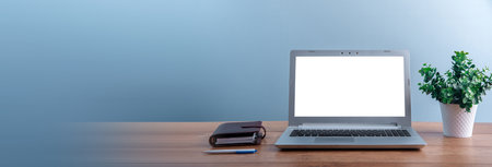 Comfortable workplace with laptop and notepad