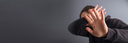 Man making stop sign on gray background