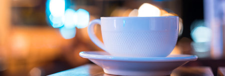 cup of coffee on night light bokeh backgroundの写真素材