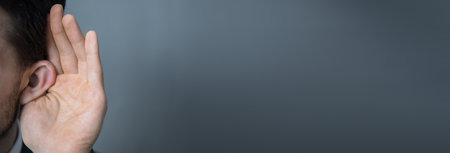 young man hand in ear and listeningの写真素材