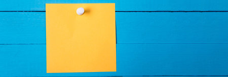 Yellow Paper Note on blue backgroundの写真素材