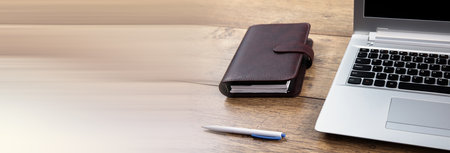 notepad with notebook and pen on working deskの写真素材