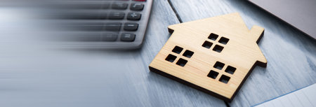 house model with calculator and notebook on tableの写真素材