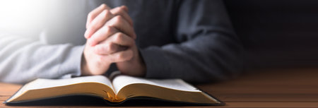 prayer man with Holy Bible on tableの写真素材