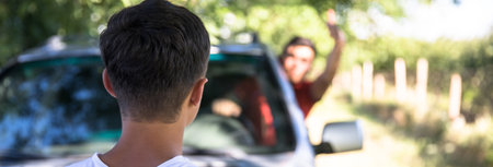 The angry man shouts at a man by in the car