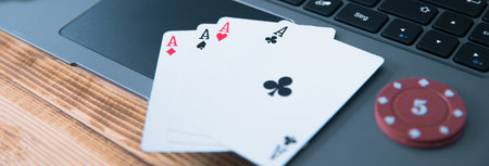 online poker with laptop and chips on table