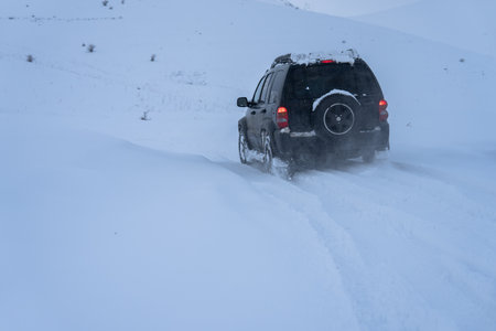 An SUV drifting in a snow fieldの写真素材