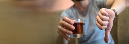 man hand glass of alcohol and bad signの写真素材