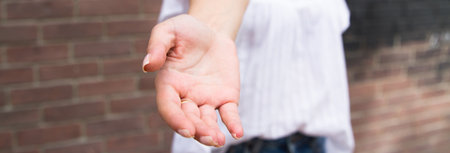 Young woman empty palm in street.