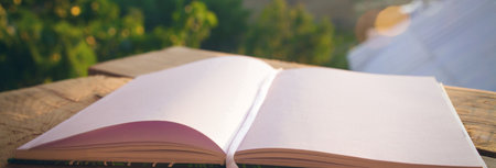 Blank empty notepad on wooden table in a park