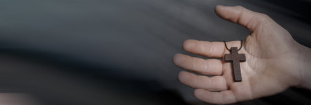 Wooden cross on praying children handの写真素材