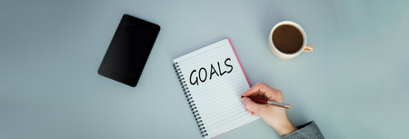 A notebook with cup of coffee and mobileの写真素材