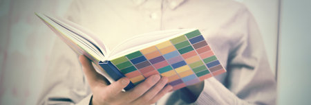 Close up view of hands holding a vintage book.の写真素材