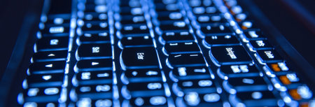 Close up of blue backlight keyboard on laptop.