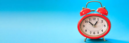 A red traditional alarm clock