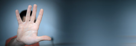 Young man doing stop gesture with hand.