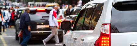 Car traffic and people on a road