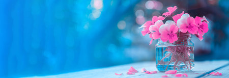 A bouquet of pink spring flowers in a glass vase