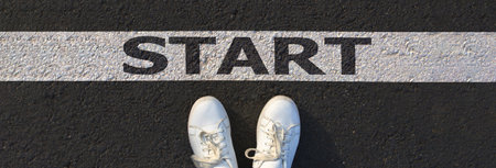 Two white sneakers on asphalt and start concept for business planning, strategy and challenge or...