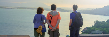 Tourists looking at a beautiful view of lake in the morning.