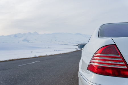 White car on asphalt road in winter, winter travelの写真素材