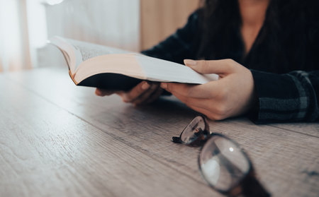 Woman reading holy book, hands close up. stock photoの写真素材