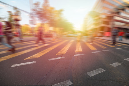 Crossing area, yellow lines, people crossing the road blurred, stock photoの写真素材