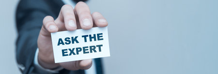 Business man holding Ask An Expert on white studio background.の写真素材