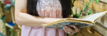 Close up of a female holding an old book.の写真素材