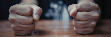 Angry businessman hit fist to table in office workstation.の写真素材