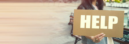 Young beautiful woman holding help sign.