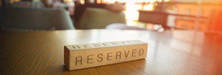 Restaurant with reserved wooden sign on table.の写真素材