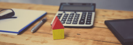 house model with calculator on office deskの写真素材