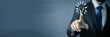 man touching light bulb in screenの写真素材