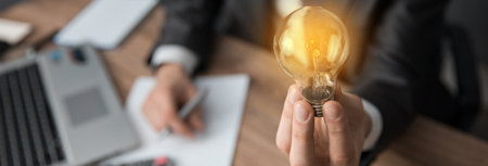 Man hand bulb on office desk